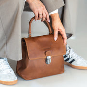 Styled Fit Perspective of Angera Full-Grain Leather Handbag on Model - Natural Daylight Drape