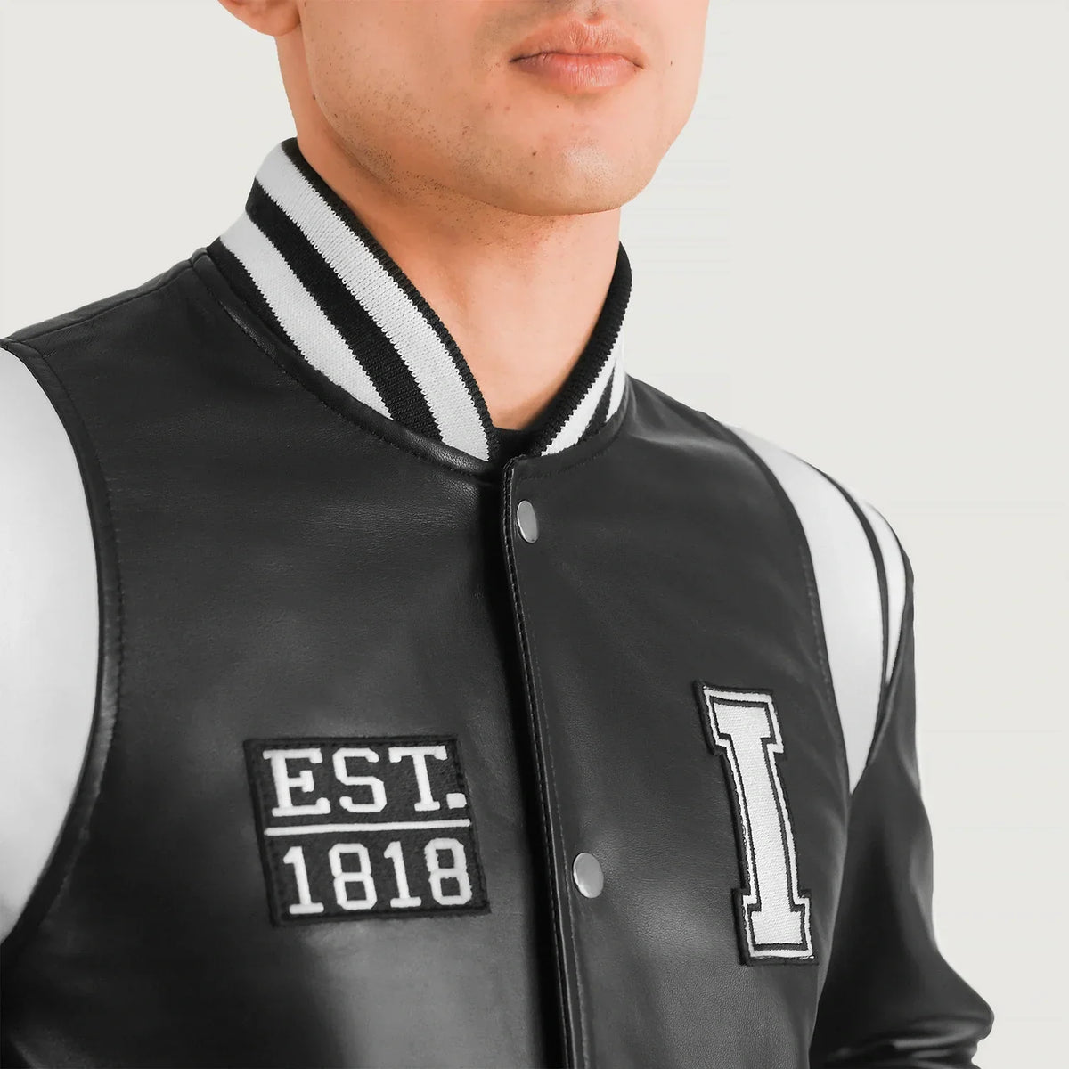 Close-Up Detail of Varsity &amp; Snap Button Hardware on Liberte Illinois Black Leather Varsity Jacket